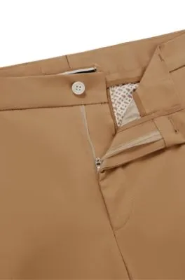 Pantalones relaxed fit de algodón elástico con cierre de botón