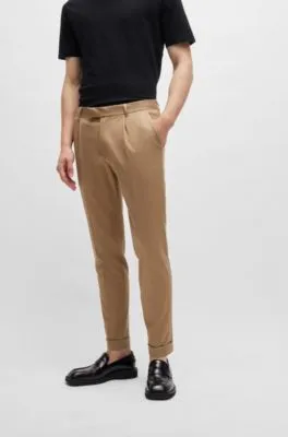 Pantalones relaxed fit en tejido elástico con pinzas