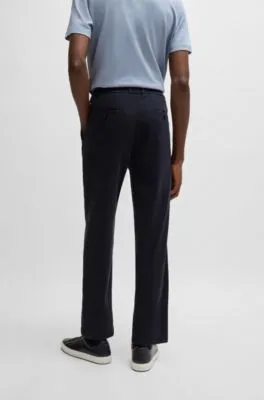 Pantalones tapered fit de tiro medio en sarga elástica