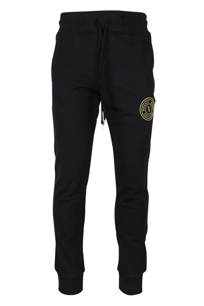 Pantalón de chándal negro con minilogo circular dorado